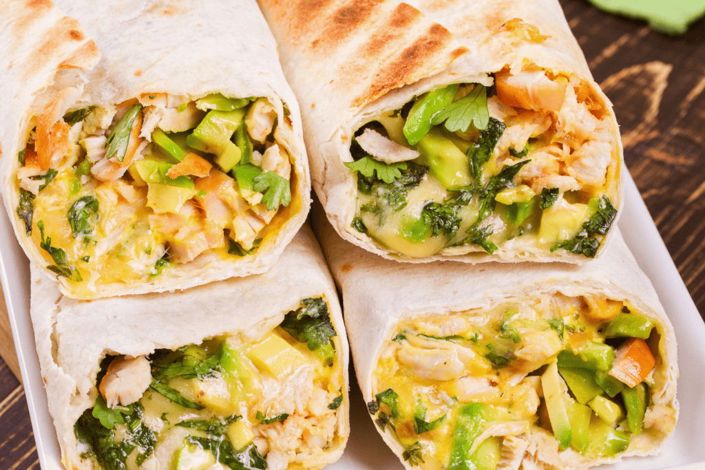 wraps with chicken, avocado, cilantro, and cheese. chicken burrito