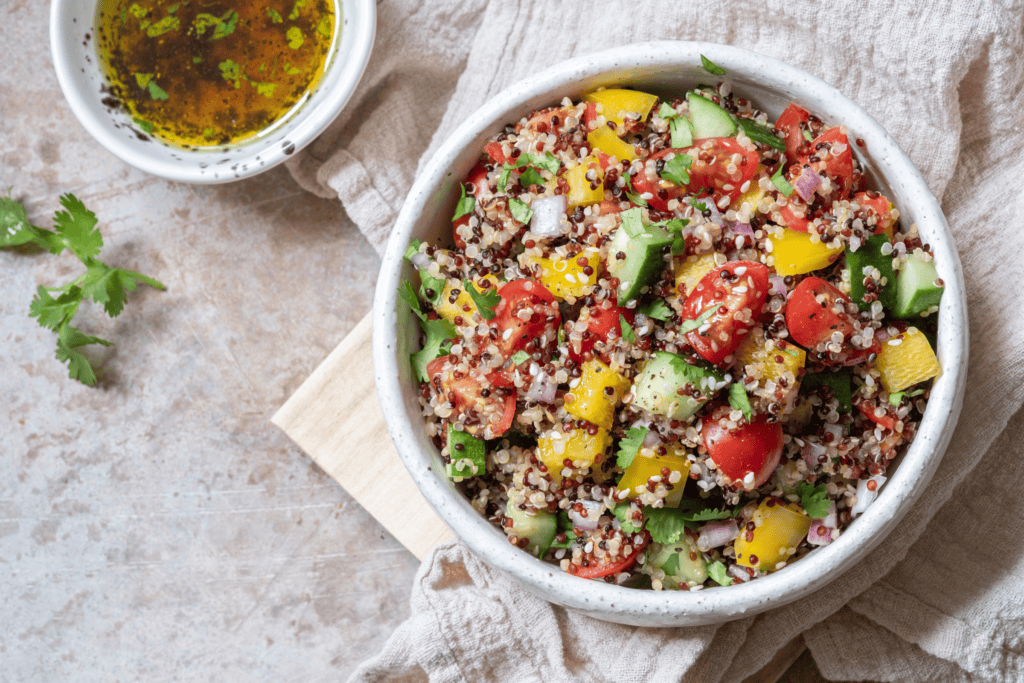 fresh quinoa tabbouleh salad with tomatoes, peppers, and cucumbers