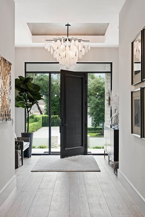 Black and white entryway with black door bench and console table