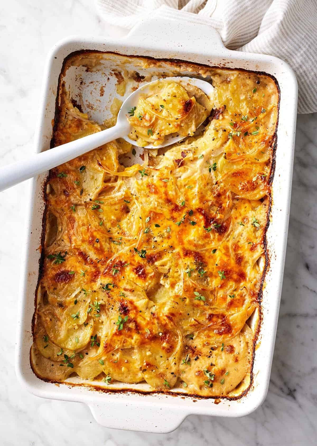 Cheesy scalloped potatoes in a baking dish