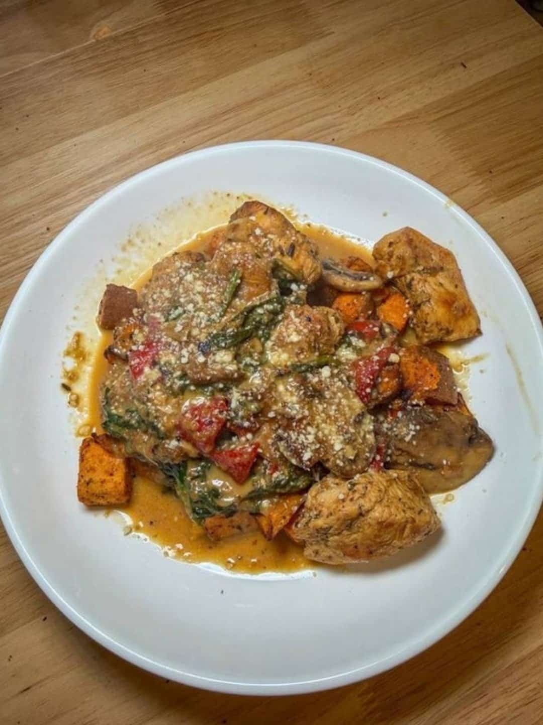 Creamy chicken with spinach, mushrooms, red peppers and roasted sweet potatoes