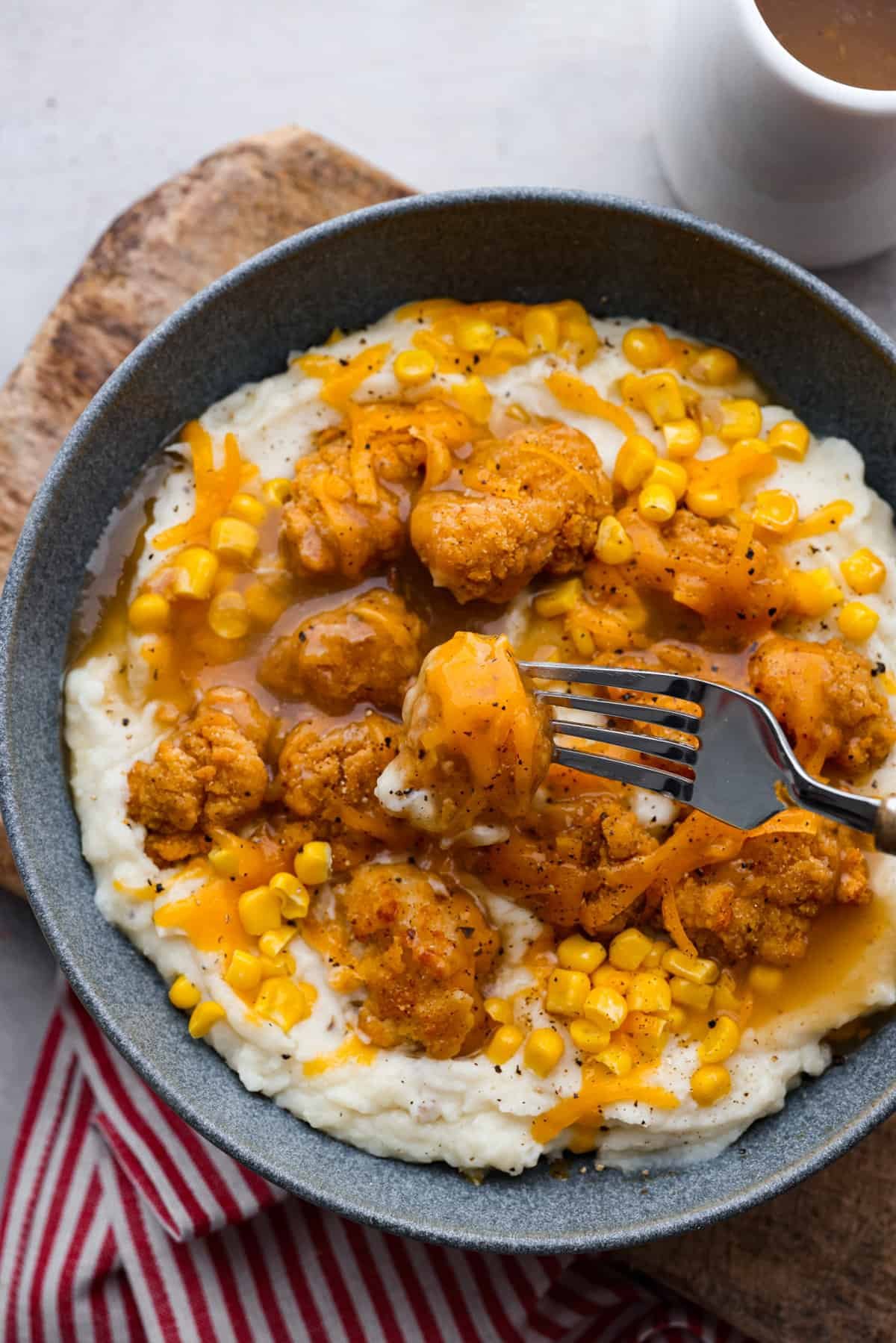 Copycat KFC famous bowl with mashed potatoes, corn, popcorn chicken and gravy