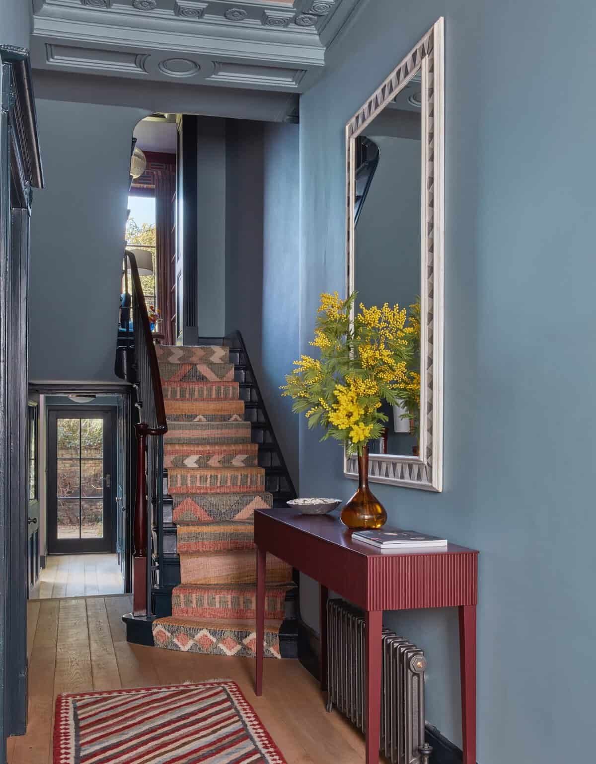 Dark moody blue painted winter entryway hallway