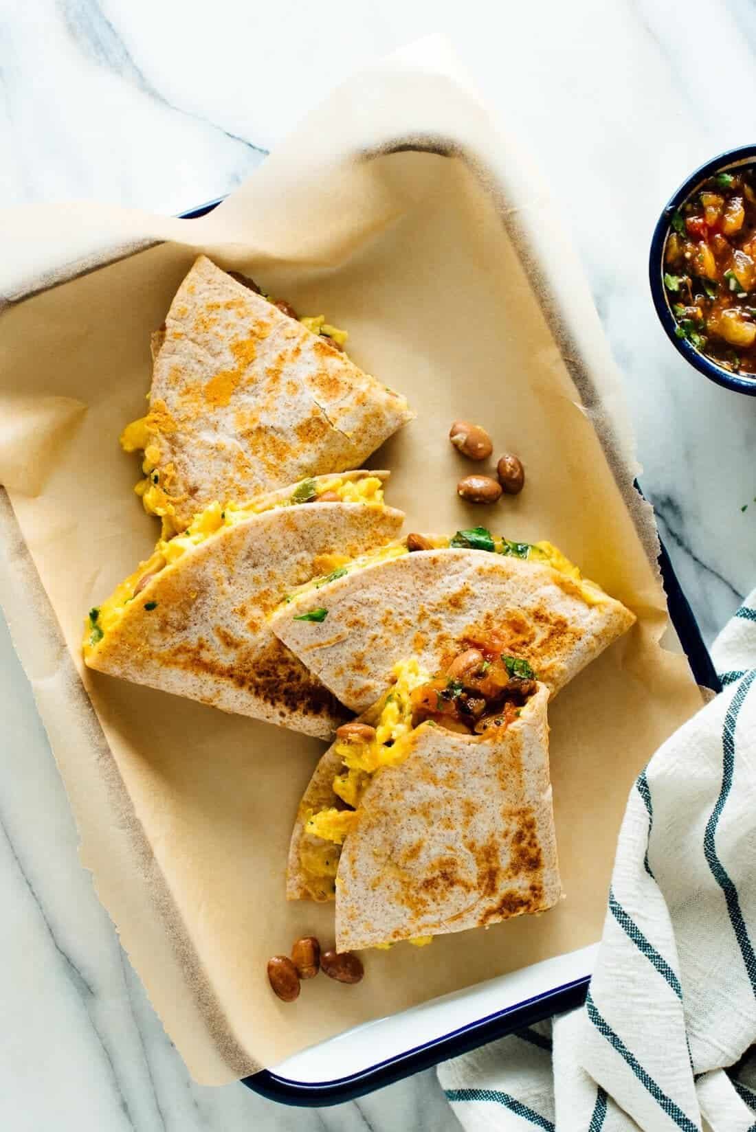 Breakfast quesadillas with scrambled eggs and beans in a baking dish