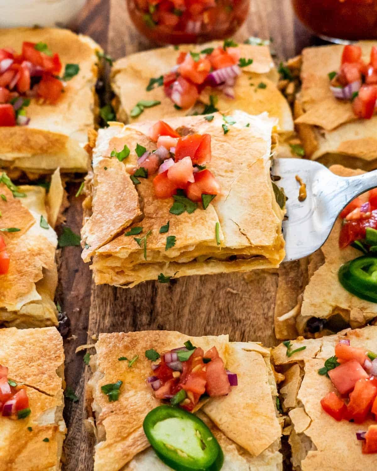 Sheet pan quesadilla cut into squares with pico de gallo