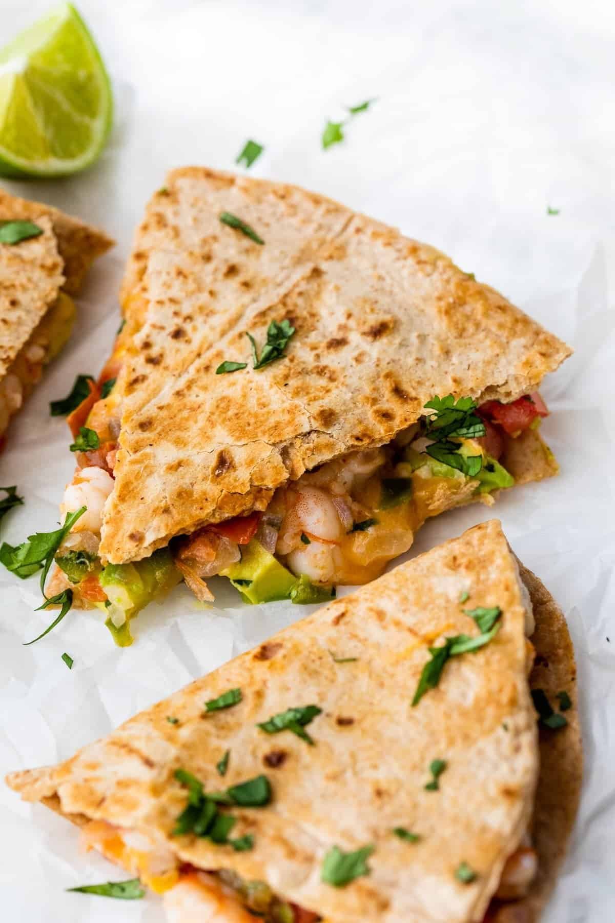 Shrimp quesadillas topped with fresh tomato avocado salsa