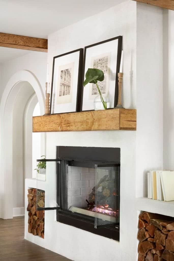 Gallery wall art above a winter fireplace mantel