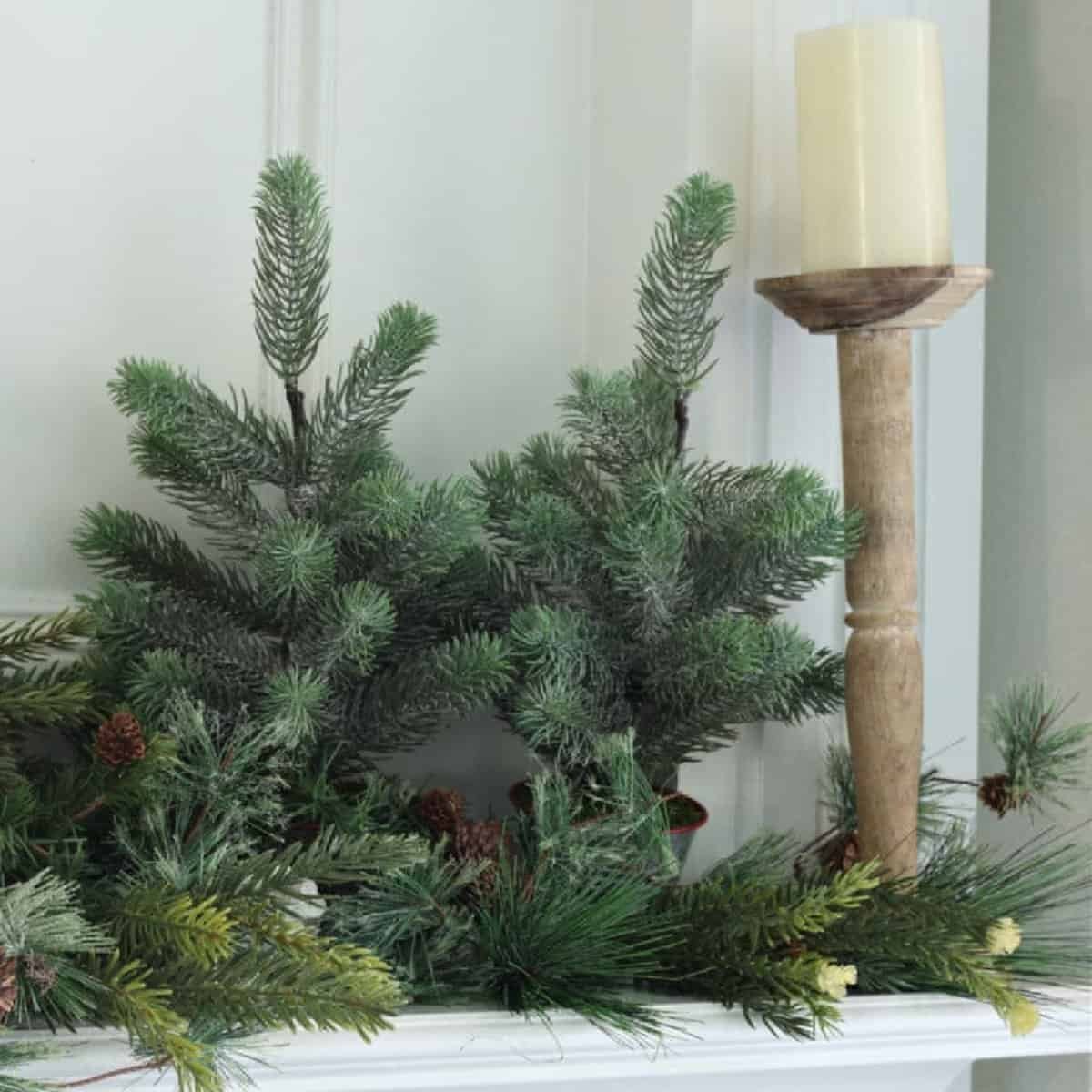 Winter fireplace mantel decorated with greenery and garland