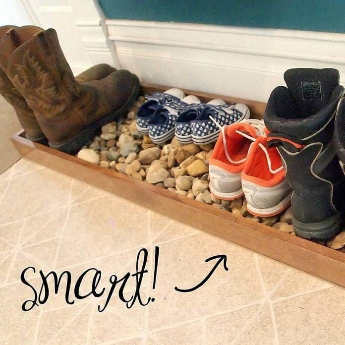 DIY wooden boot tray with river rocks for winter mudroom organization