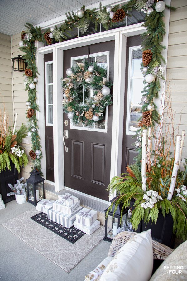 Elegant Christmas front door with layered pre-lit garland and silver and chartreuse ornaments
