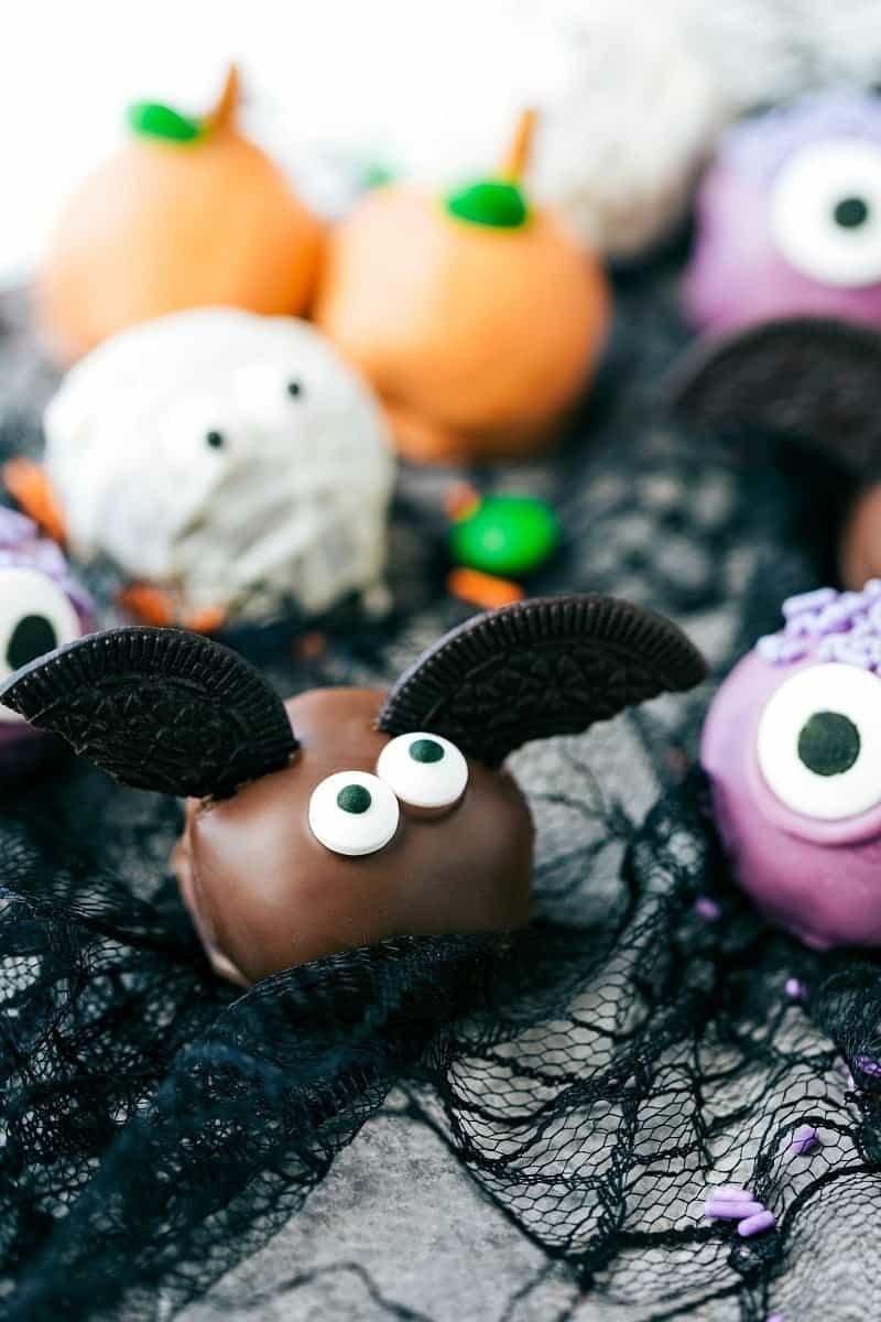 Halloween Oreo balls decorated as monsters and bats with candy eyes
