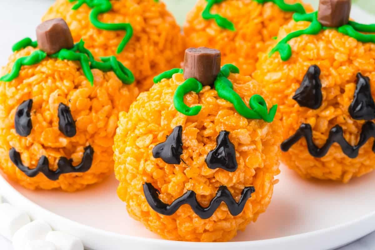 Orange pumpkin shaped Rice Krispie treats with Tootsie Roll stems