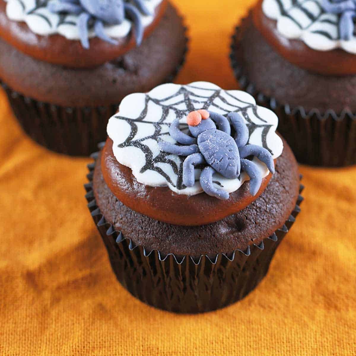 Chocolate Halloween cupcakes with fondant spider webs and spiders