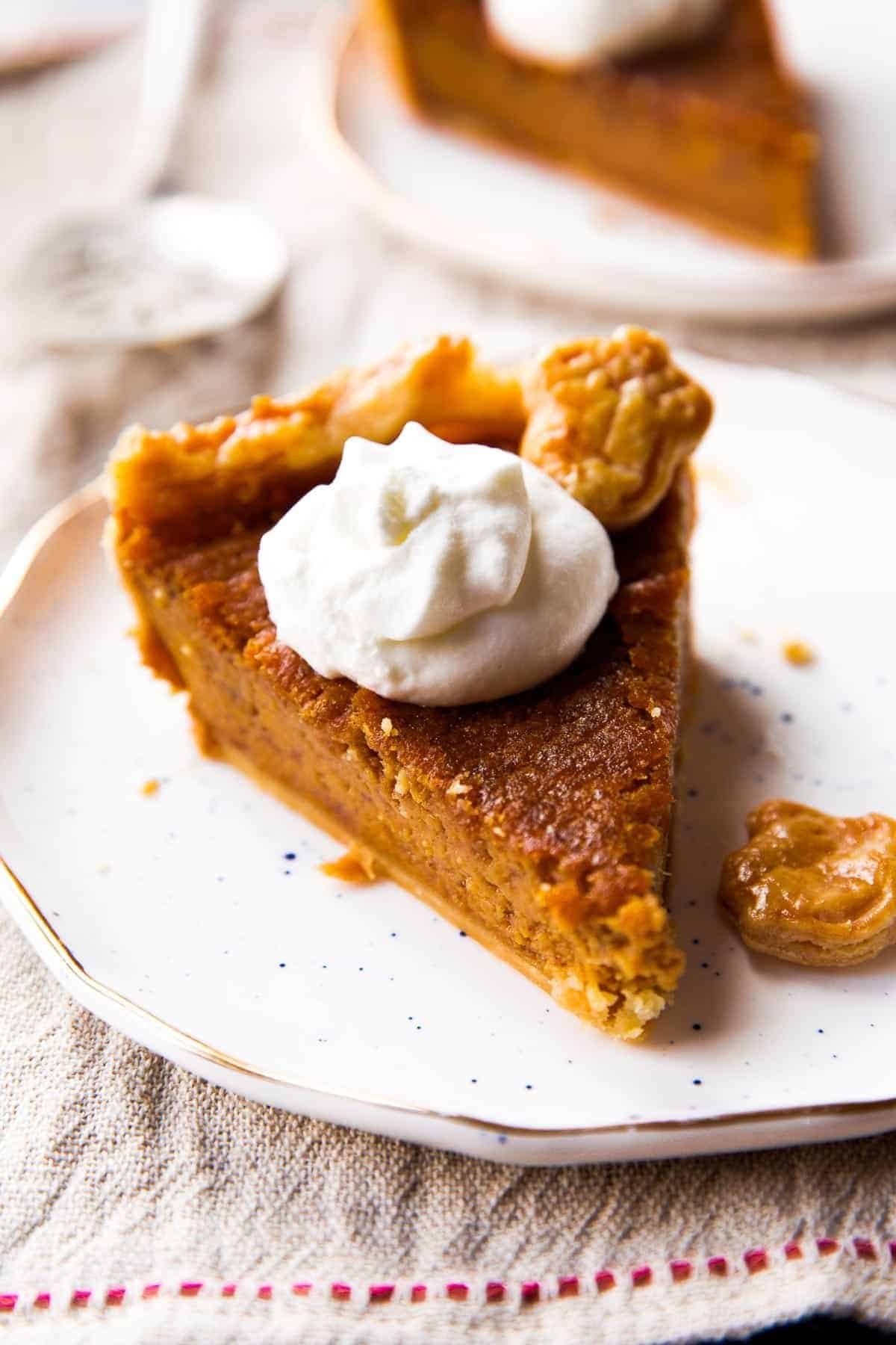 Slice of brown sugar sweet potato pie with whipped cream