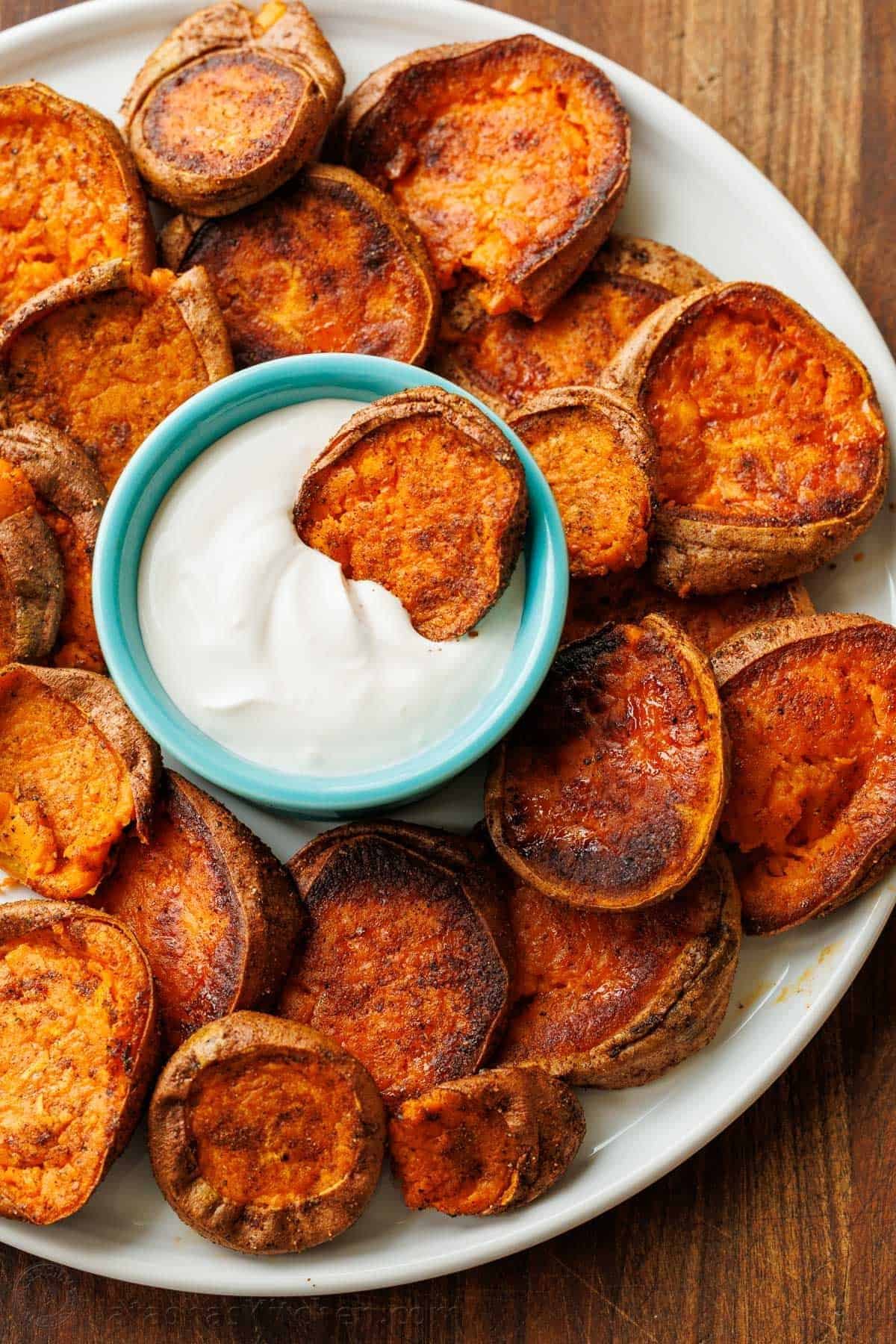 Crispy smashed sweet potatoes with yogurt dipping sauce