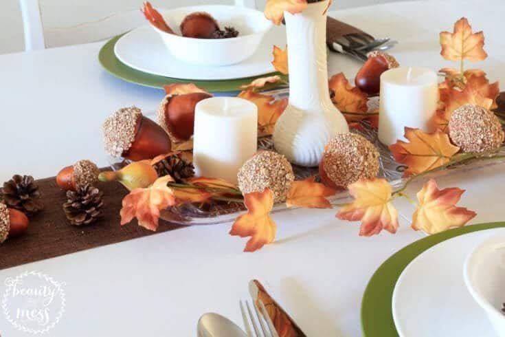 Dollar store Thanksgiving tablescape with a burlap runner, green chargers and pinecones
