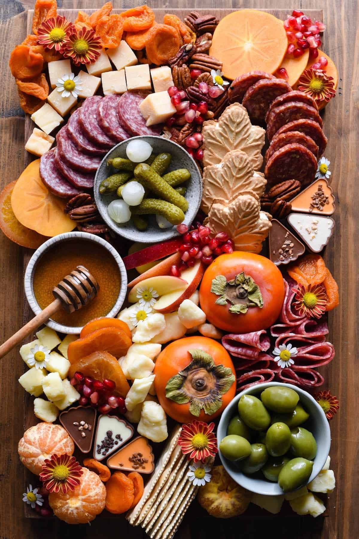 Thanksgiving charcuterie board with salami, cheese, fall fruit and crackers