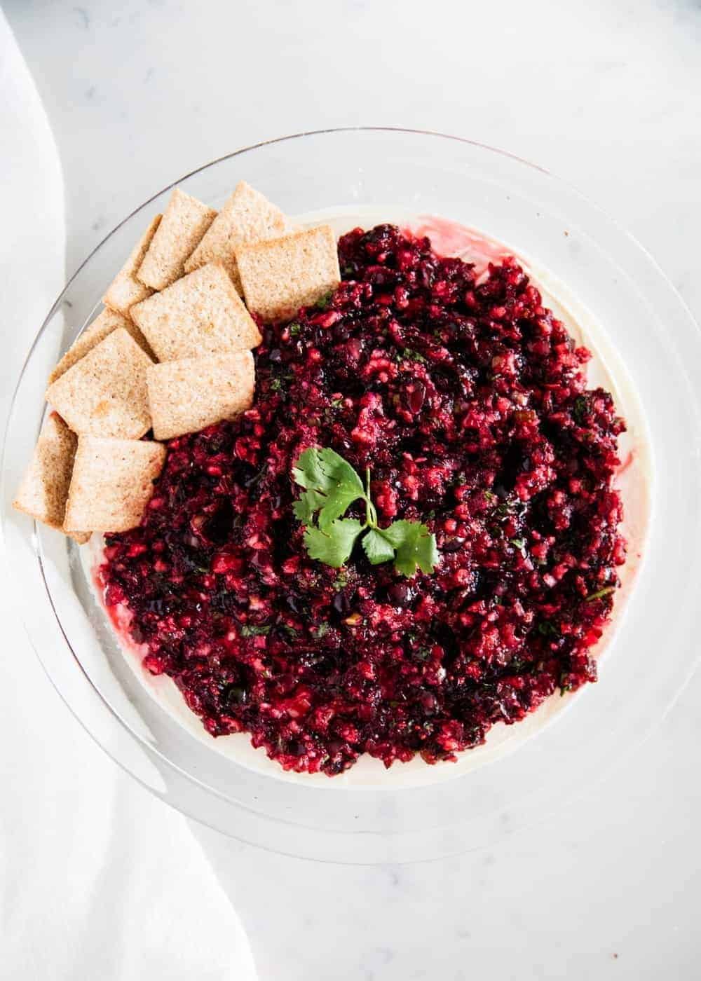 Cranberry jalapeno salsa over cream cheese with crackers