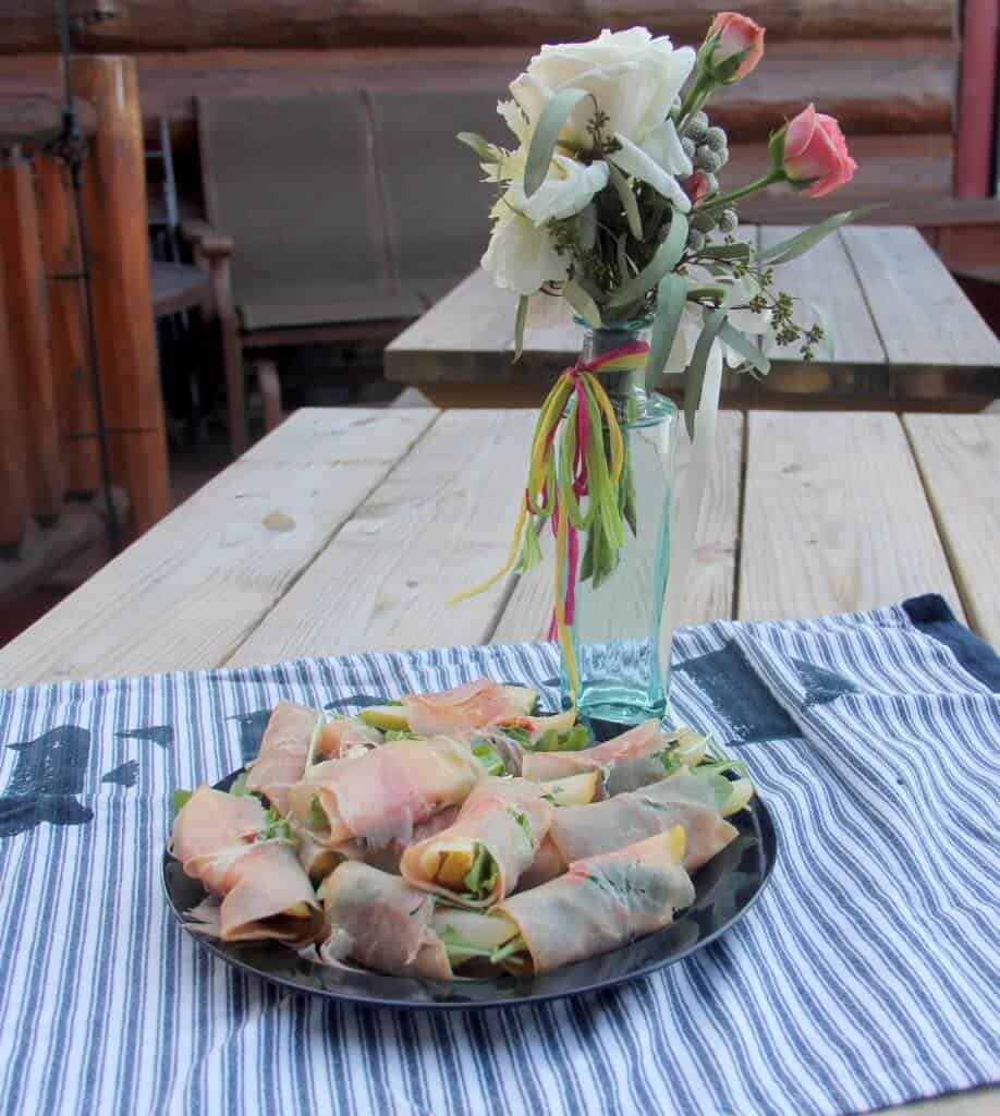 Prosciutto wrapped pears with arugula and goat cheese