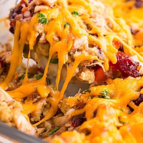 Layered leftover turkey casserole with mashed potatoes, stuffing, gravy and cheese