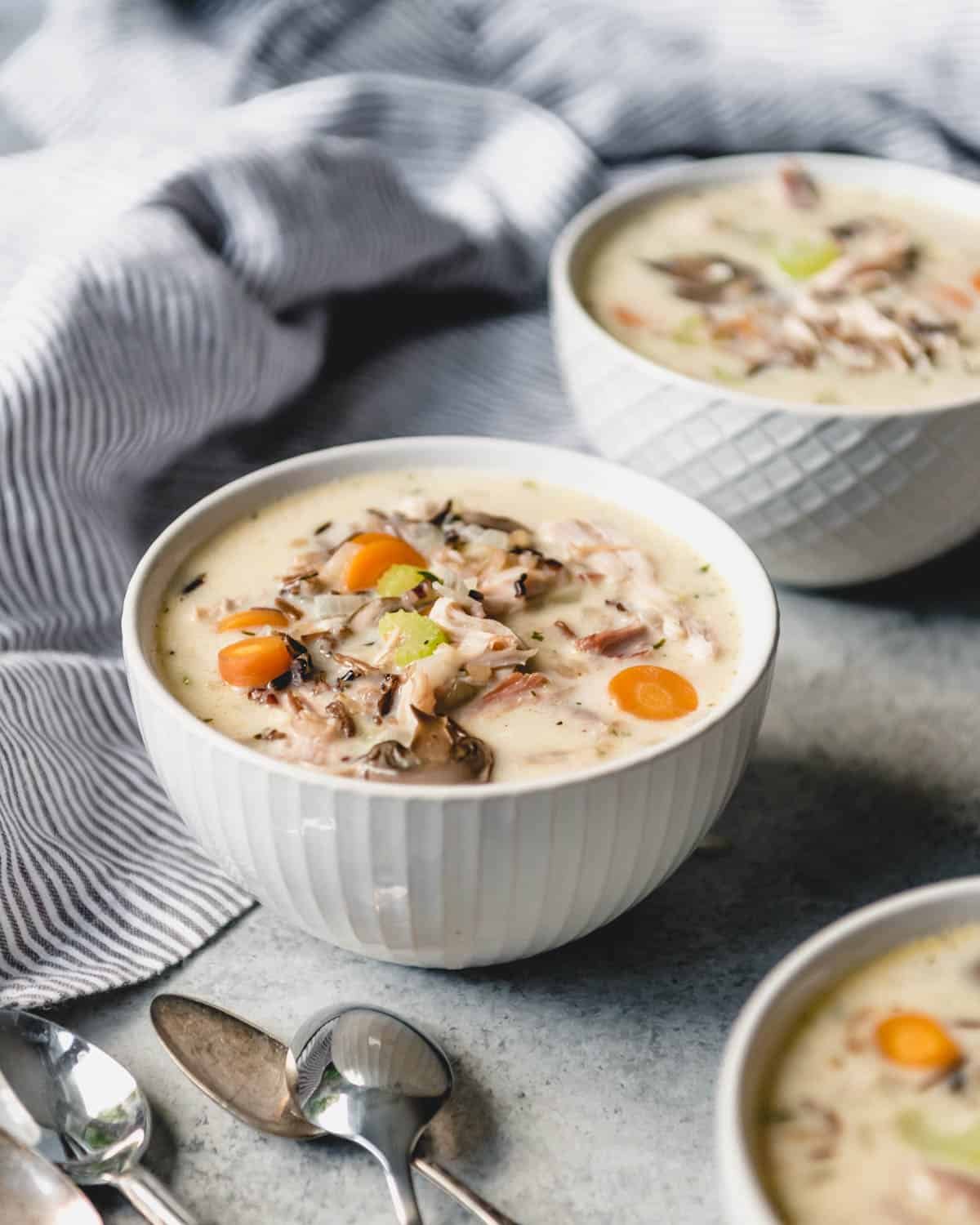 Bowl of creamy turkey wild rice soup with carrots and mushrooms